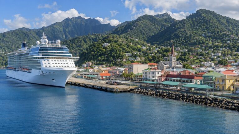 Cruise ship beside Roseau waterfront with green volcanic hills in Dominica