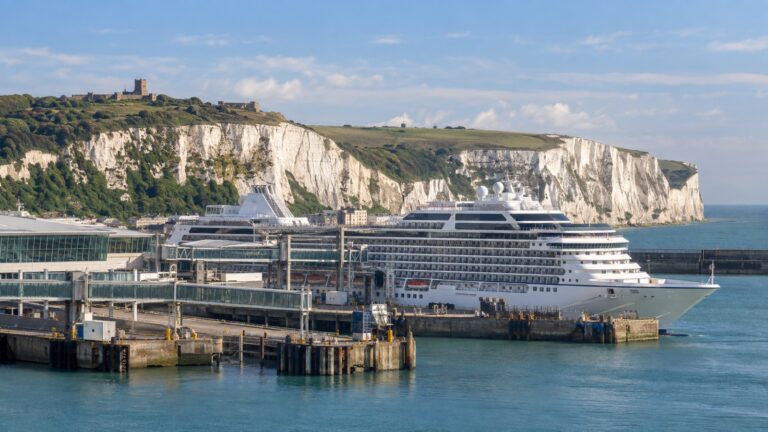 Port of Dover Western Docks cruise terminal with a white cruise ship beneath the White Cliffs of Dover