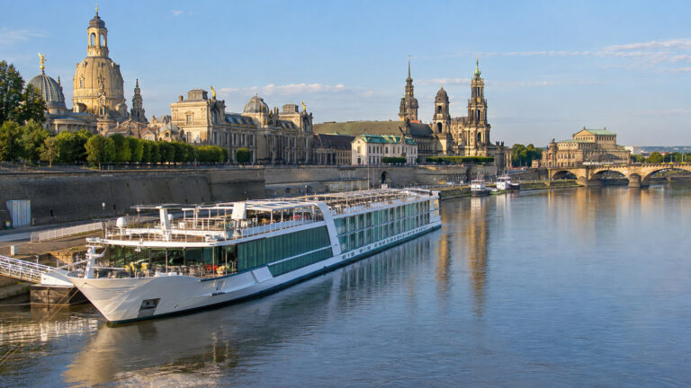 River cruise vessel at a Dresden Elbe berth with historic skyline beyond