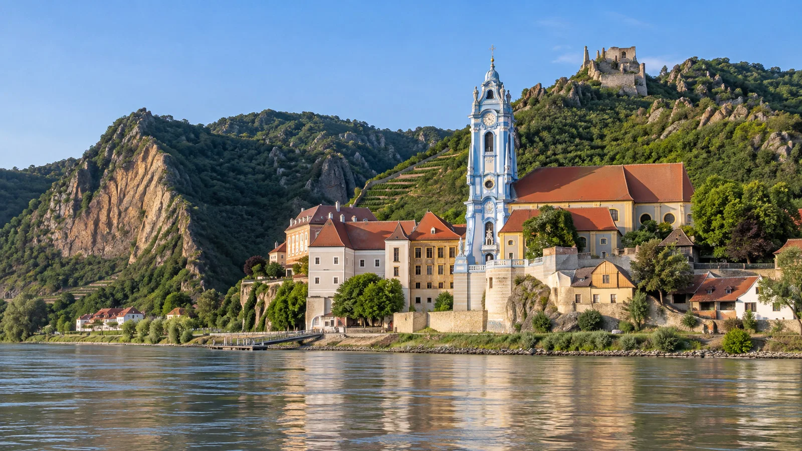 Blue and white bell tower of Dürnstein Abbey above the Danube
