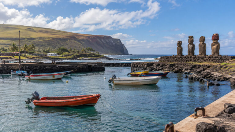 Small tender boats and moai at Hanga Roa harbor on Easter Island