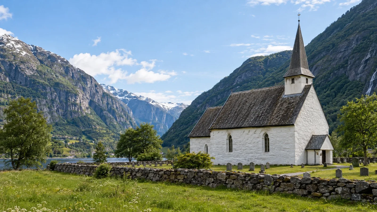 White stone Old Eidfjord Church in a mountain valley