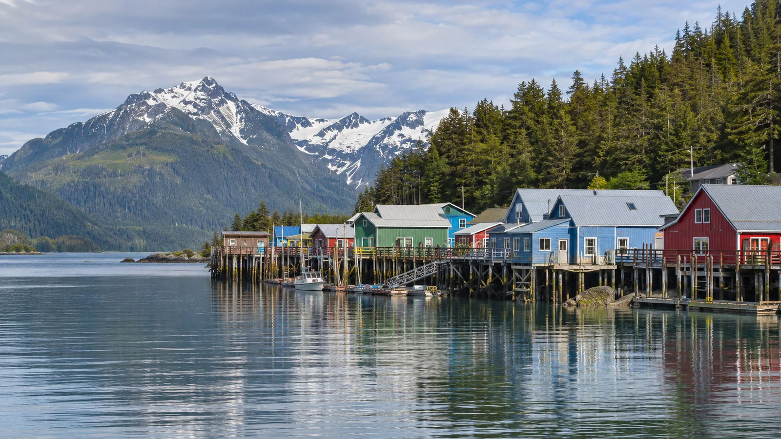 Pelican Alaska fishing village waterfront with colorful low buildings on pilings along Lisianski Inlet, no people