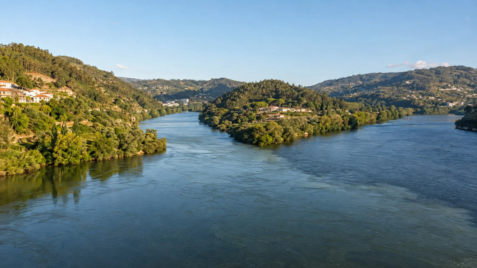 Confluence of Tamega and Douro rivers at Entre-os-Rios Portugal with two wide waterways meeting among green hills