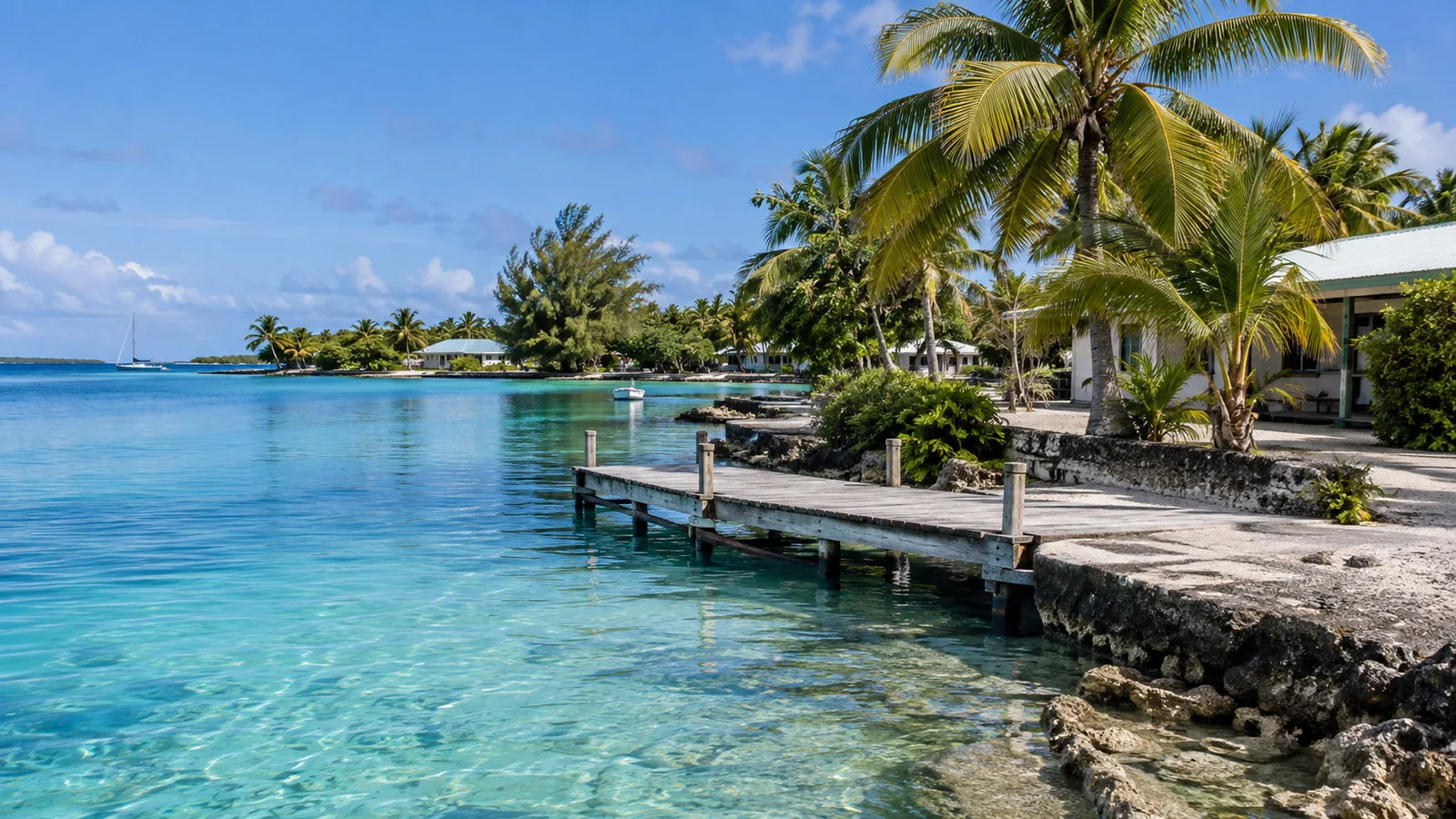 Quiet Rotoava village lagoon landing on Fakarava atoll with small wooden jetty and palms, no people