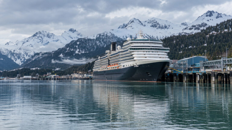 Alaska cruise ship at a chilly early-season port with snow on mountains