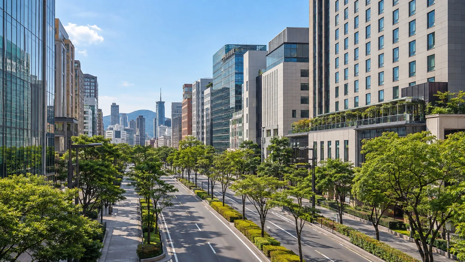 Tenjin district of Fukuoka with fashionable hotel buildings, broad tree-lined streets and modern Japanese city architecture