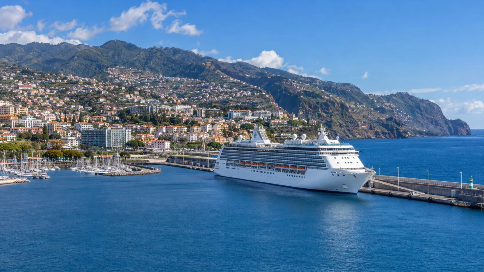 Cruise ship at Funchal harbor with Madeira’s terraced hillside city behind