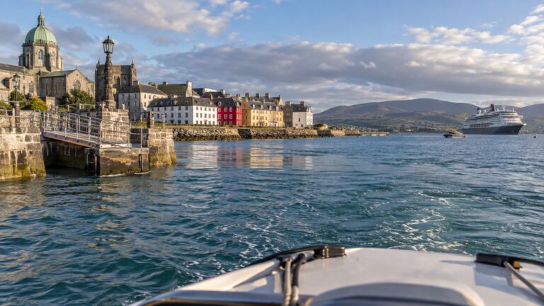 Tender boat approaching Galway harbor from an anchored ship