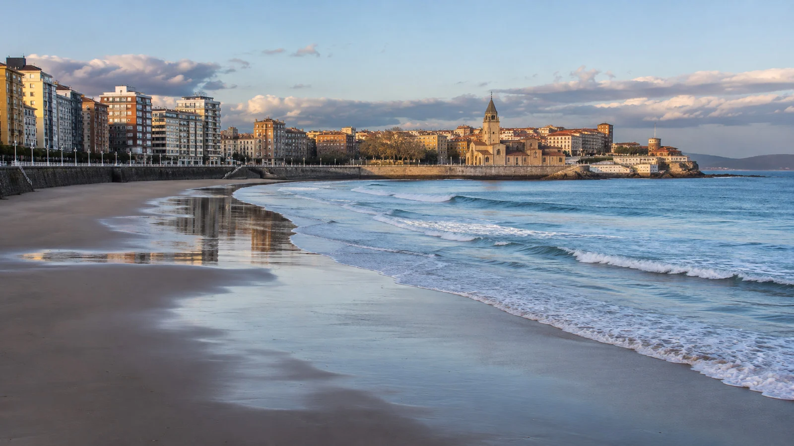 San Lorenzo Beach Gijon Spain long crescent beach and bay under soft Atlantic light, no people