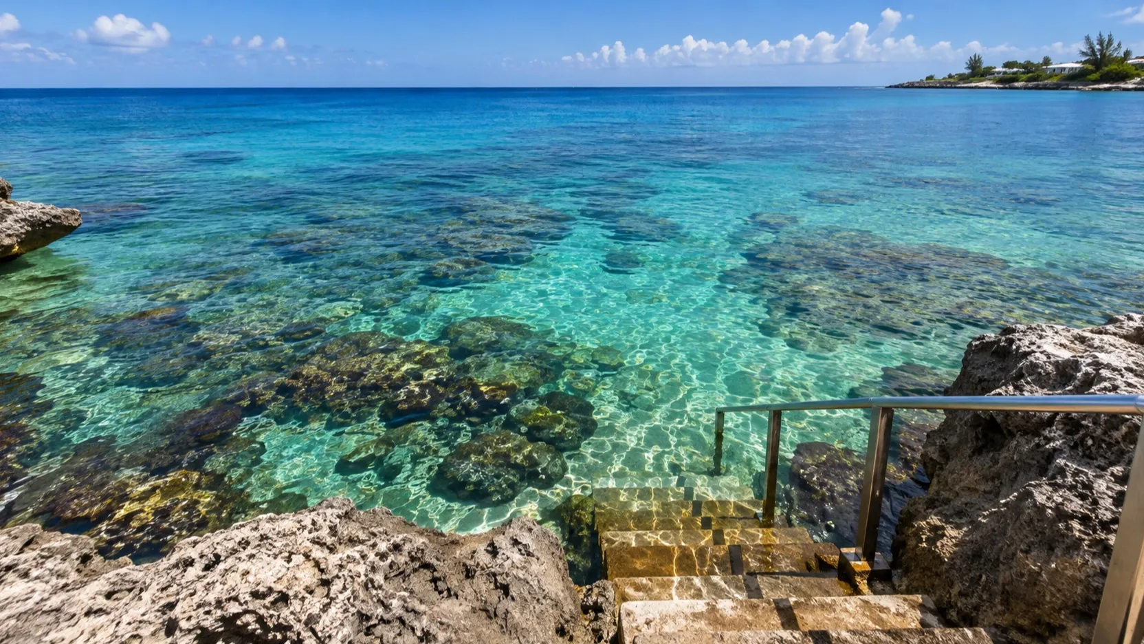 Steps into clear Grand Cayman water above a shallow reef