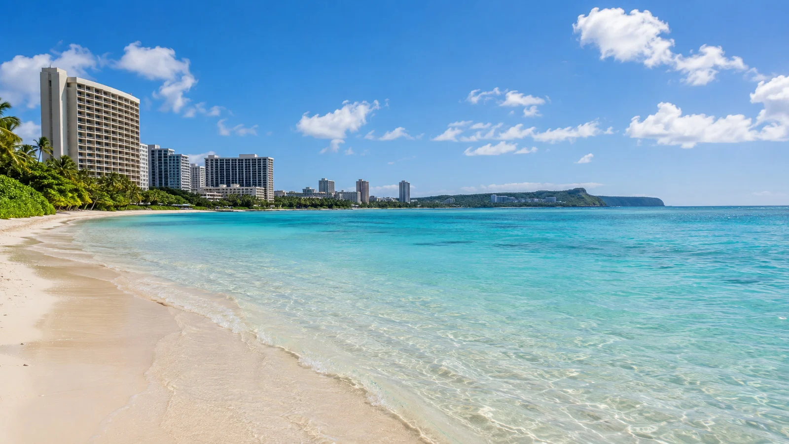 Turquoise water and pale sand at Tumon Bay beach