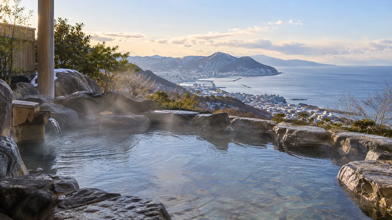 Steaming outdoor onsen overlooking the coast near Hakodate, Japan