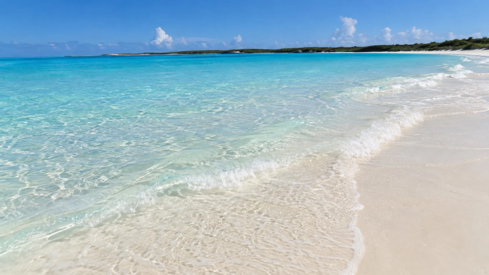 Clear shallow swimming water along the beach at Half Moon Cay