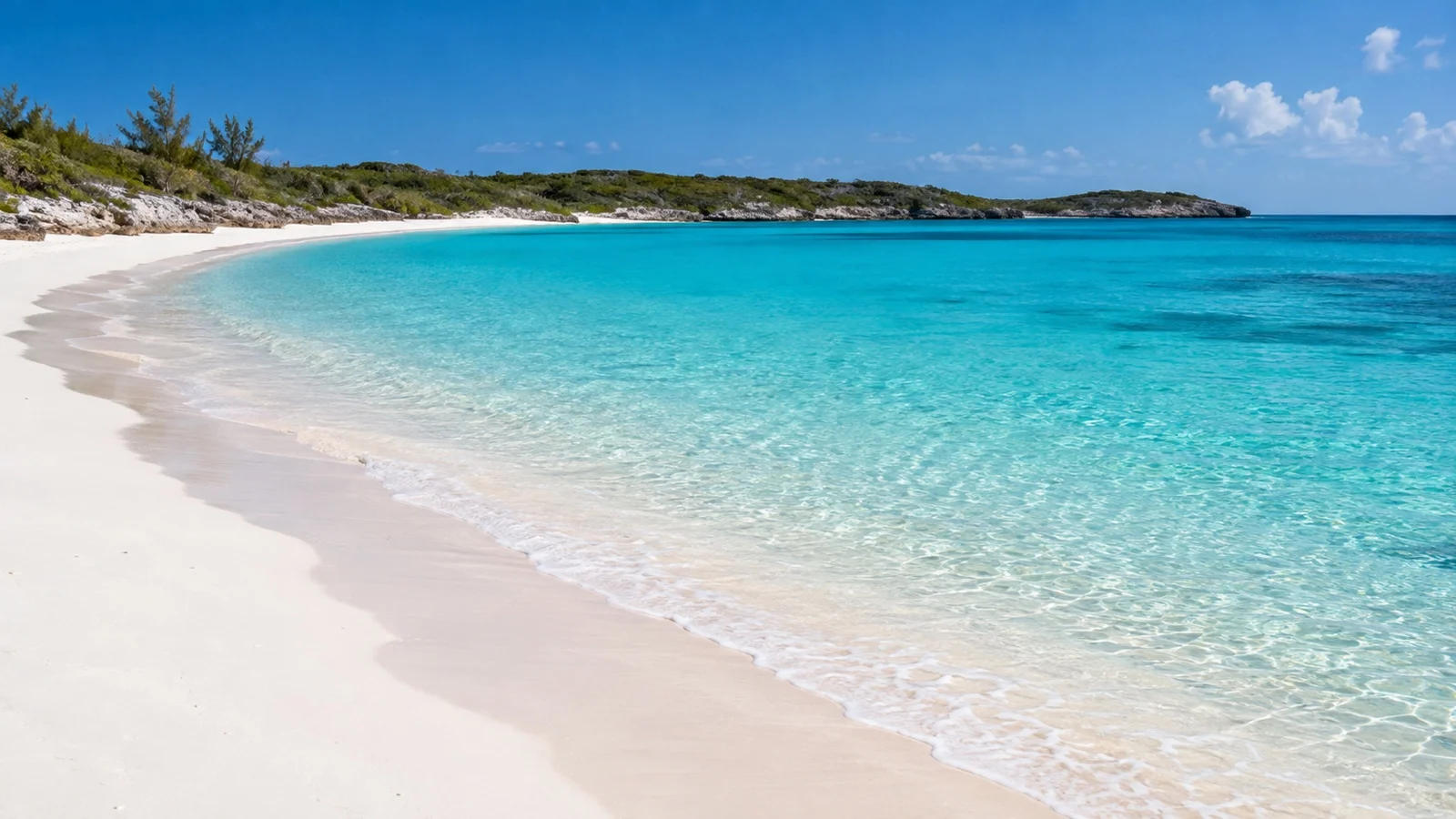 Empty white sand shore and turquoise bay at Half Moon Cay in the Bahamas
