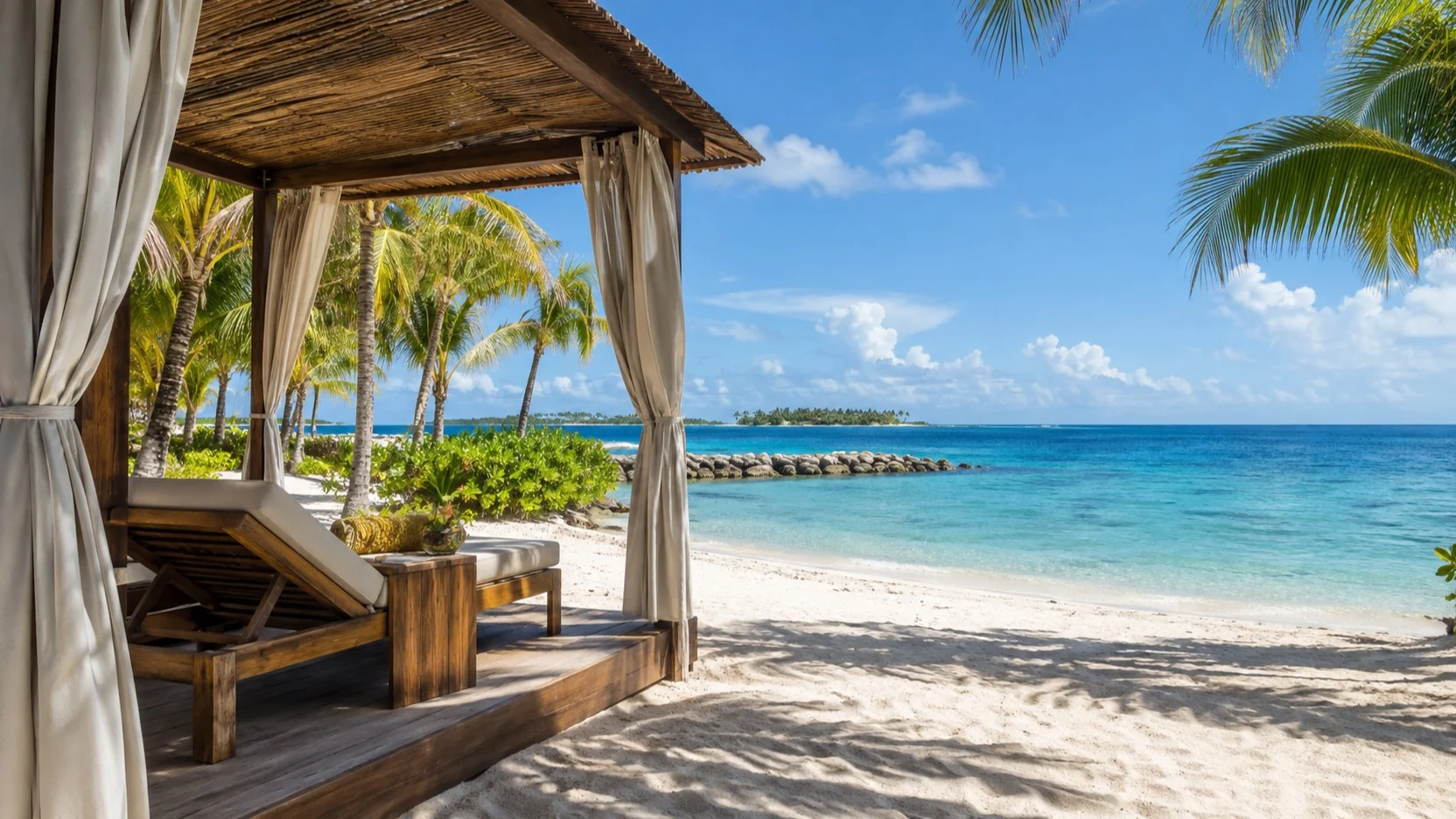 An empty beach cabana beside turquoise water on Harvest Caye