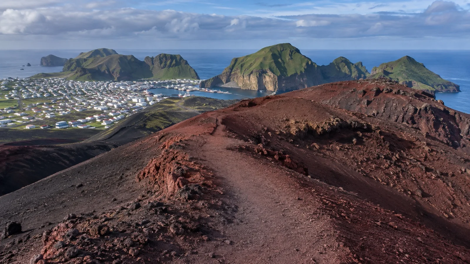 Red and black slopes of Eldfell volcano above Heimaey