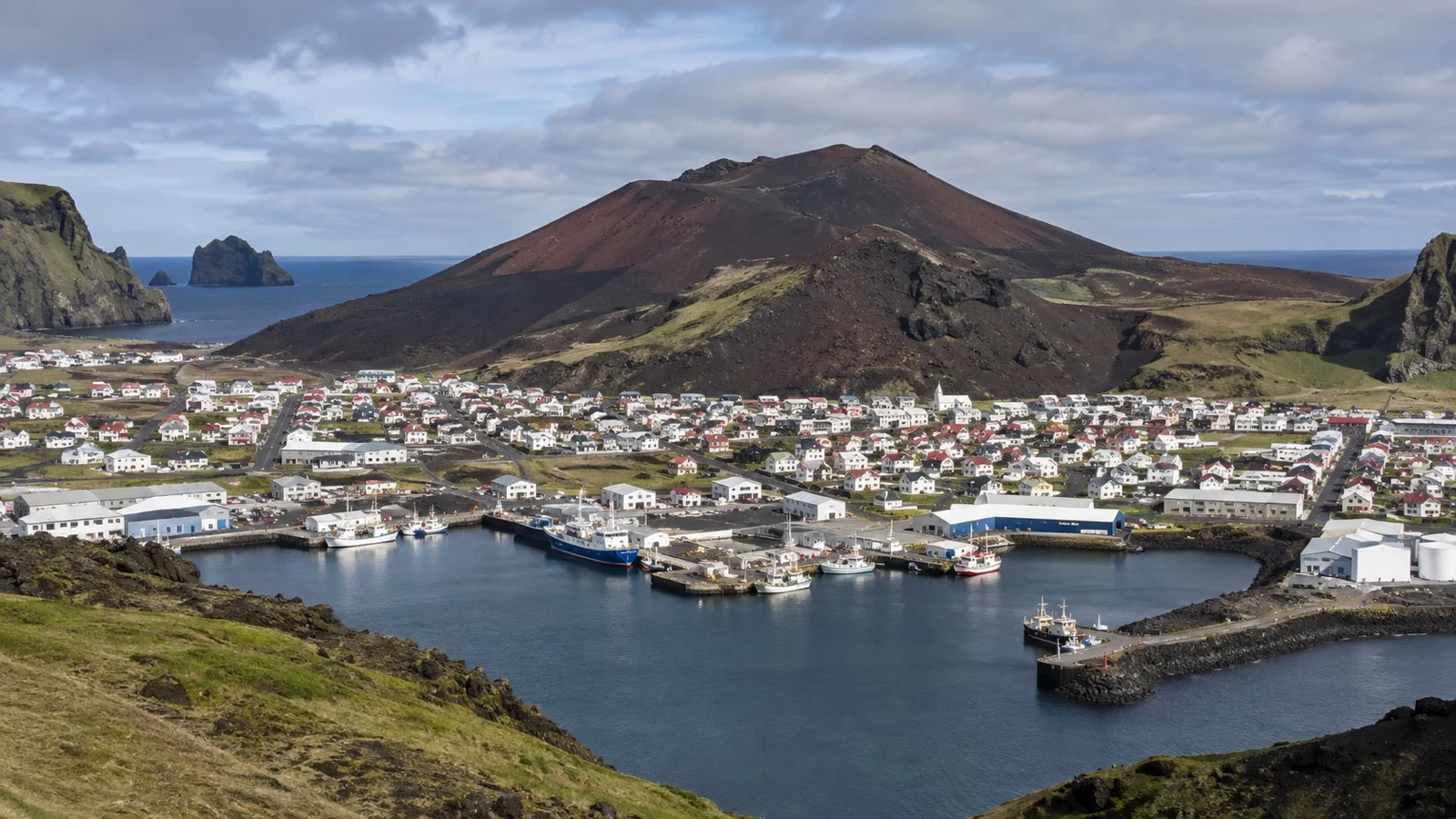 Heimaey harbor town below the Eldfell volcanic cone