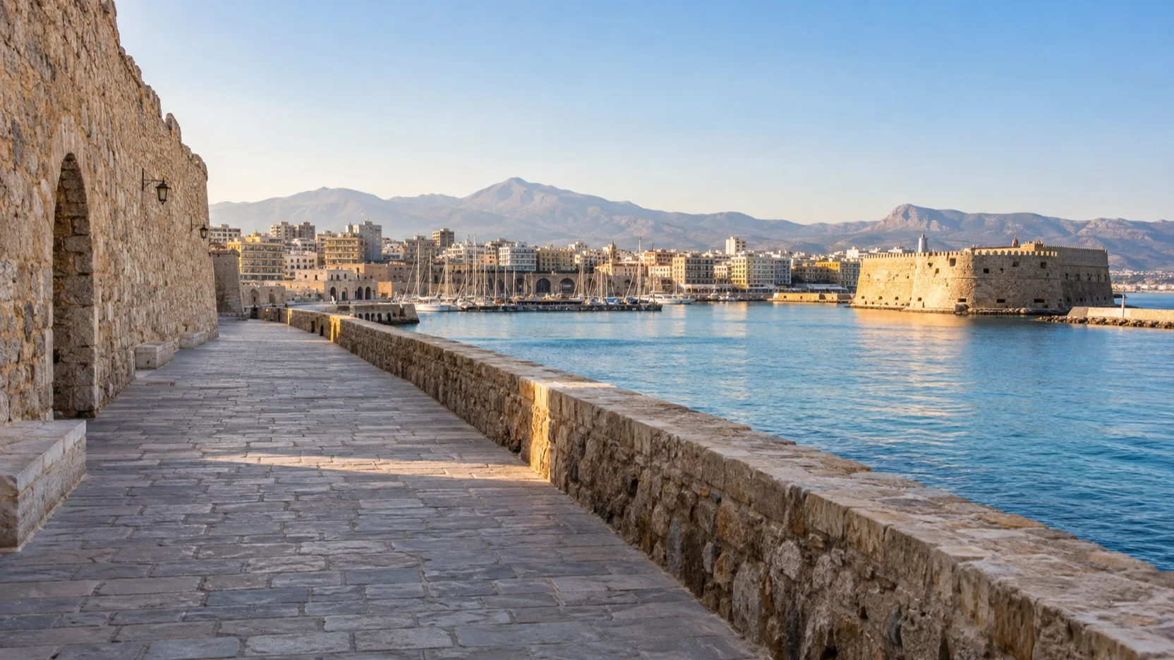 Empty Venetian harbor wall leading toward central Heraklion