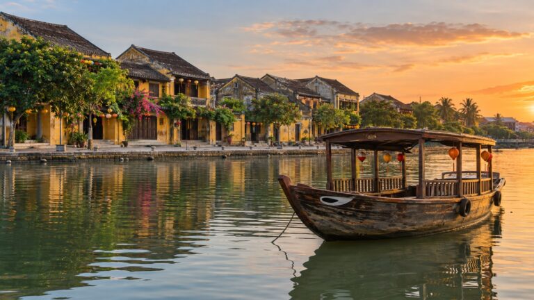 Small covered wooden boat on the Thu Bon River beside Hoi An