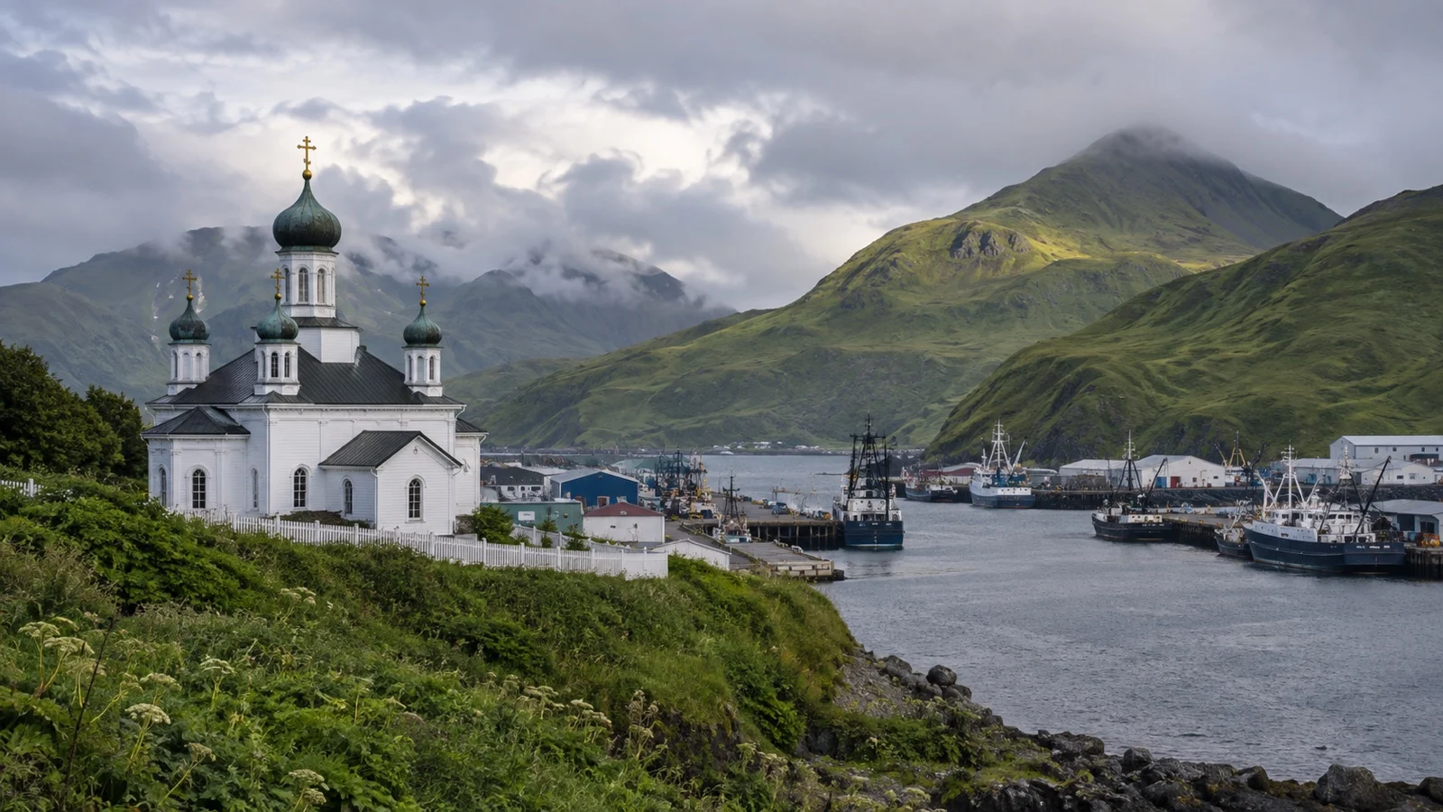 Historic Holy Ascension Cathedral in Unalaska against green hills