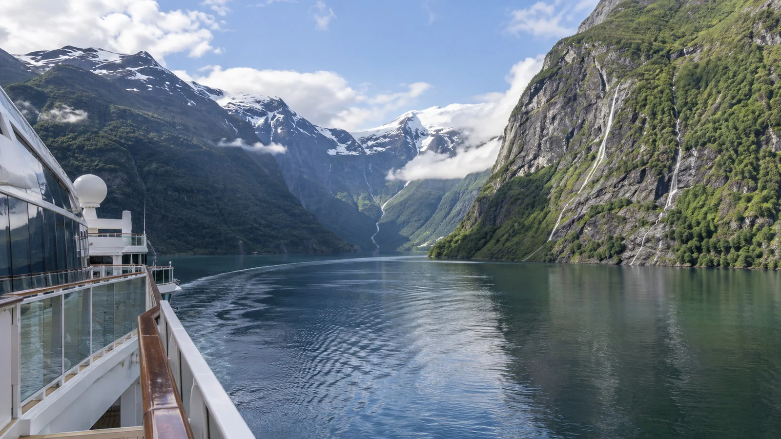 Cruise ship sailing through a Norwegian fjord without docking
