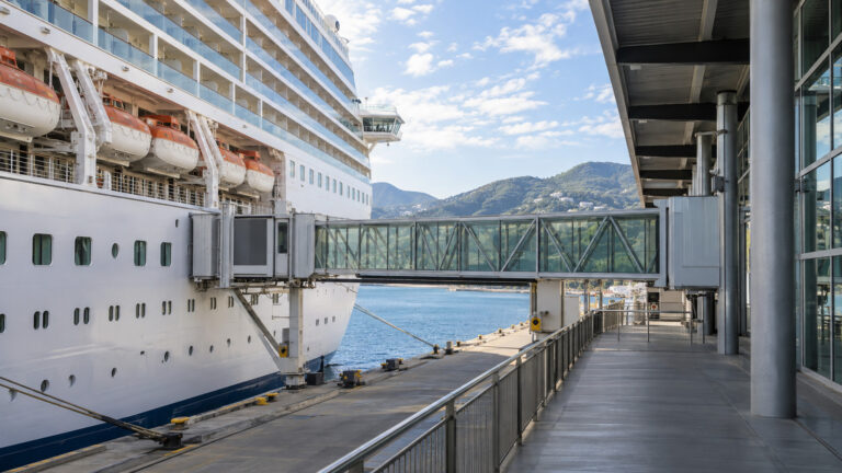 Ocean cruise ship at a berth with an empty terminal gangway