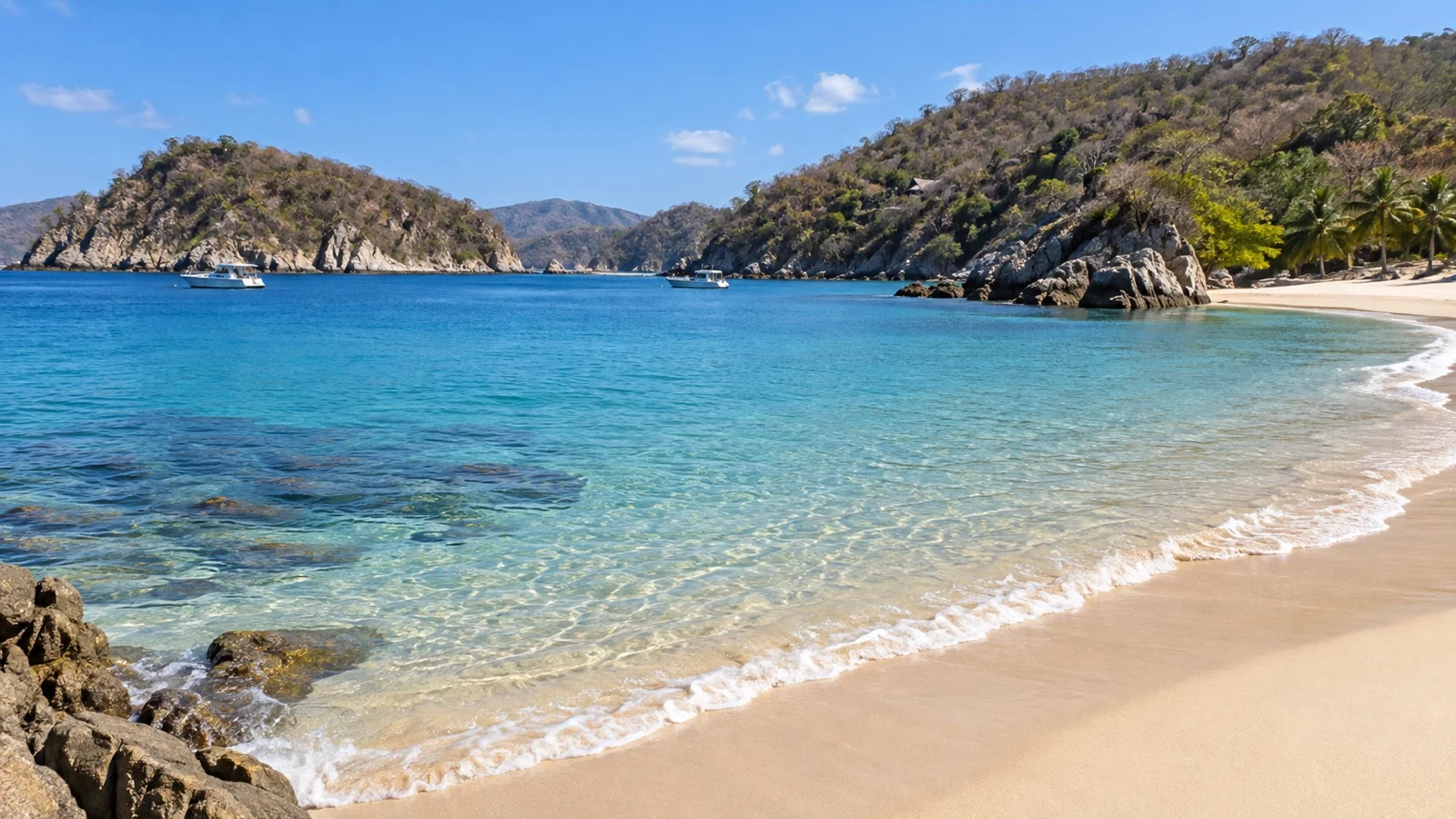 Empty pale beach and sheltered water in Huatulco’s San Agustín Bay