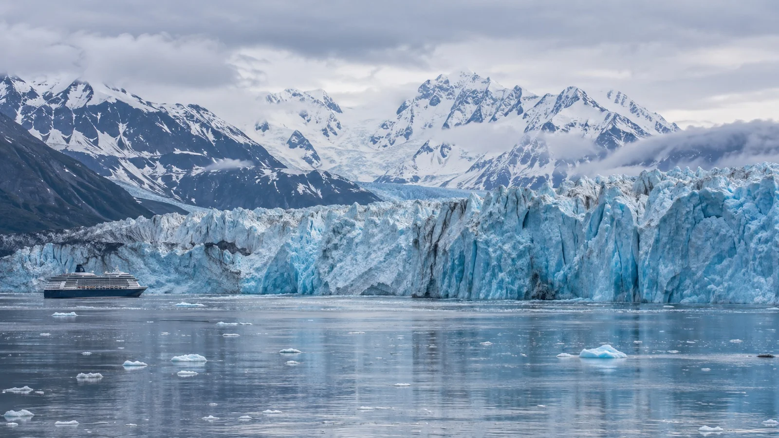 Hubbard Glacier’s broad blue ice front seen from the water in Alaska.