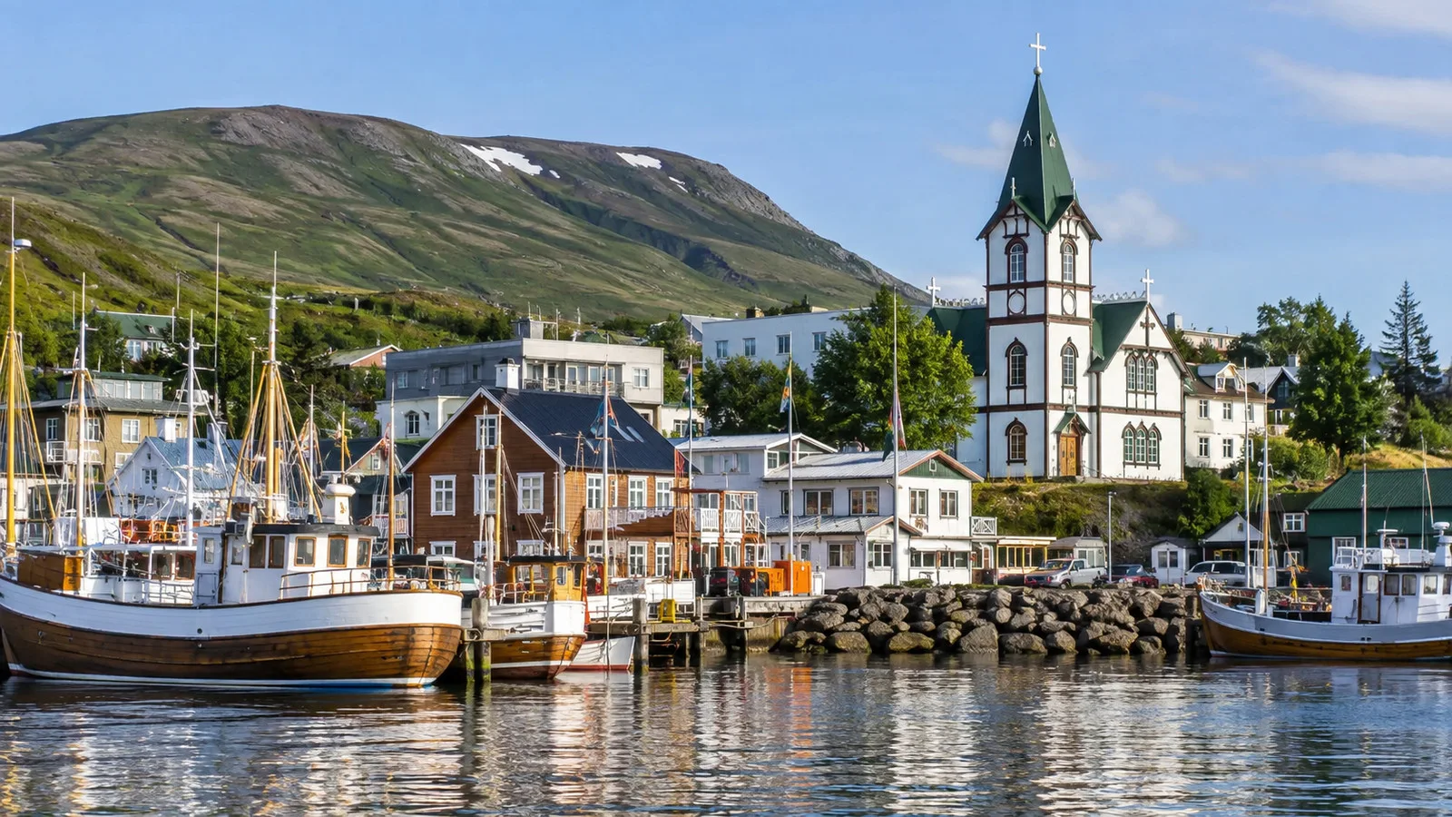 White Húsavík church beside the harbor