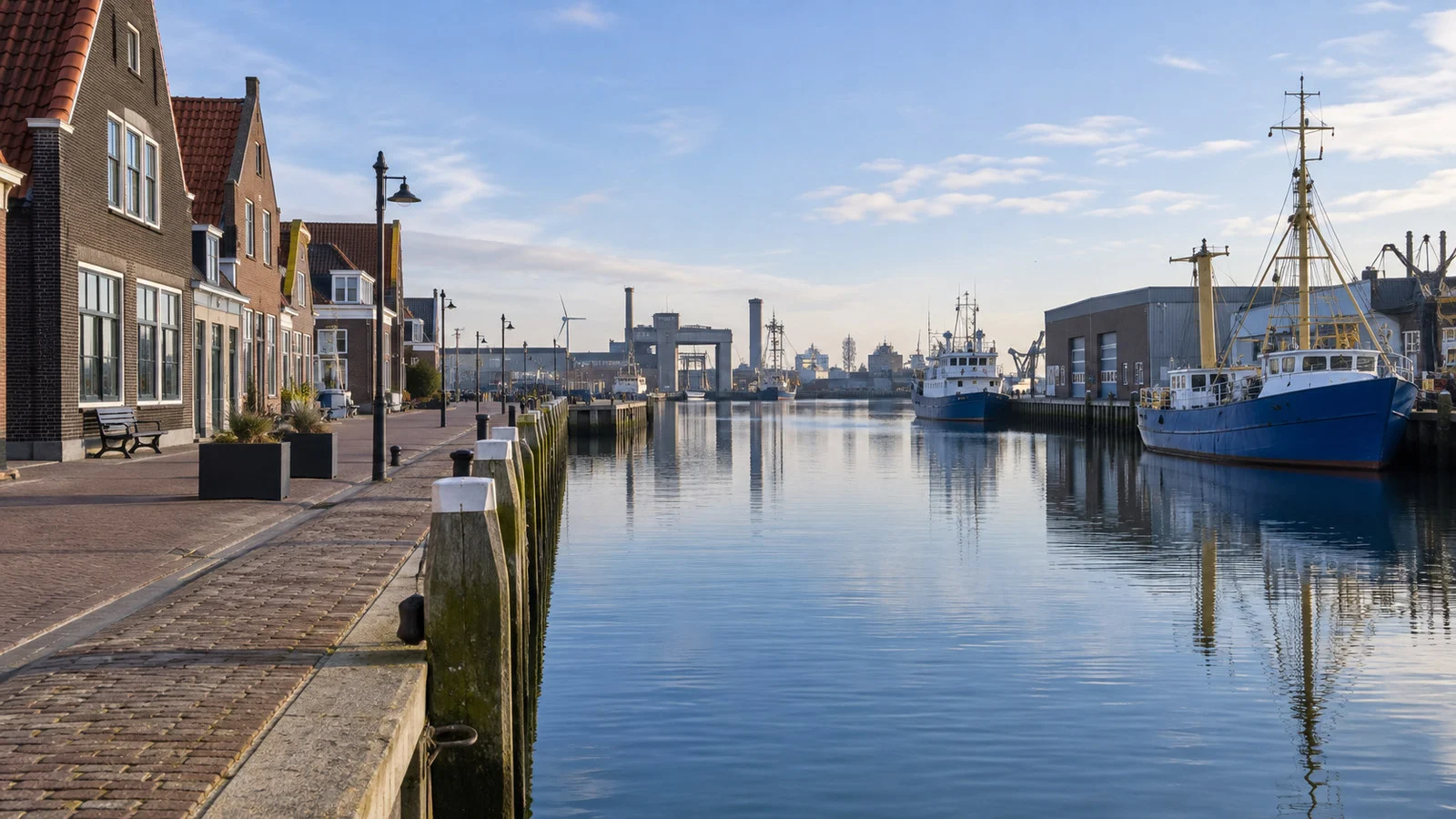 Quiet IJmuiden Netherlands harbor town street with maritime buildings and canal, no people