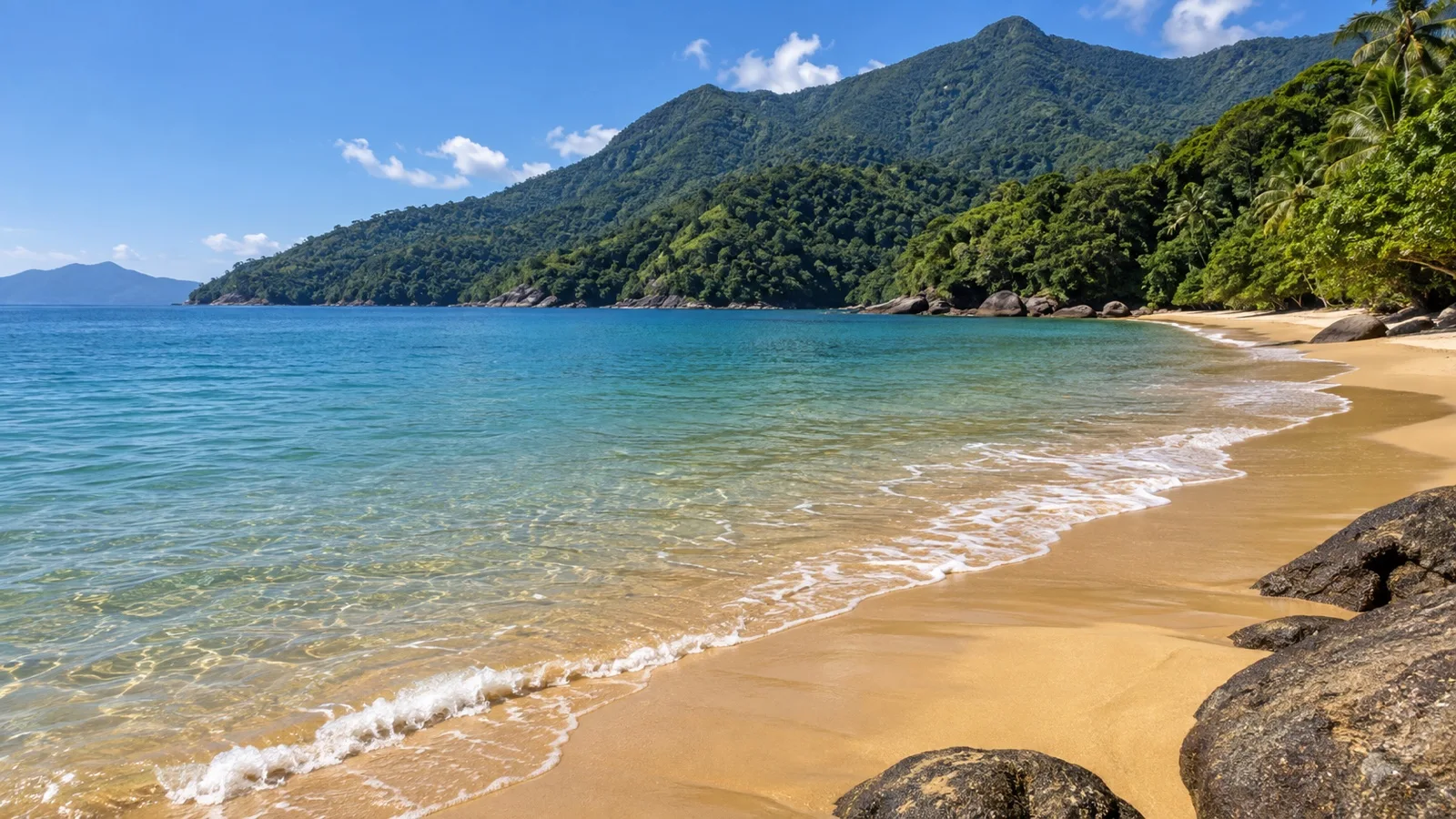 Sandy beach and Atlantic Forest hills on Ilhabela