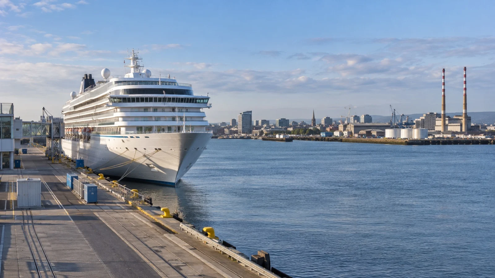 Cruise ship at Dublin Port with harbor quays and city buildings beyond