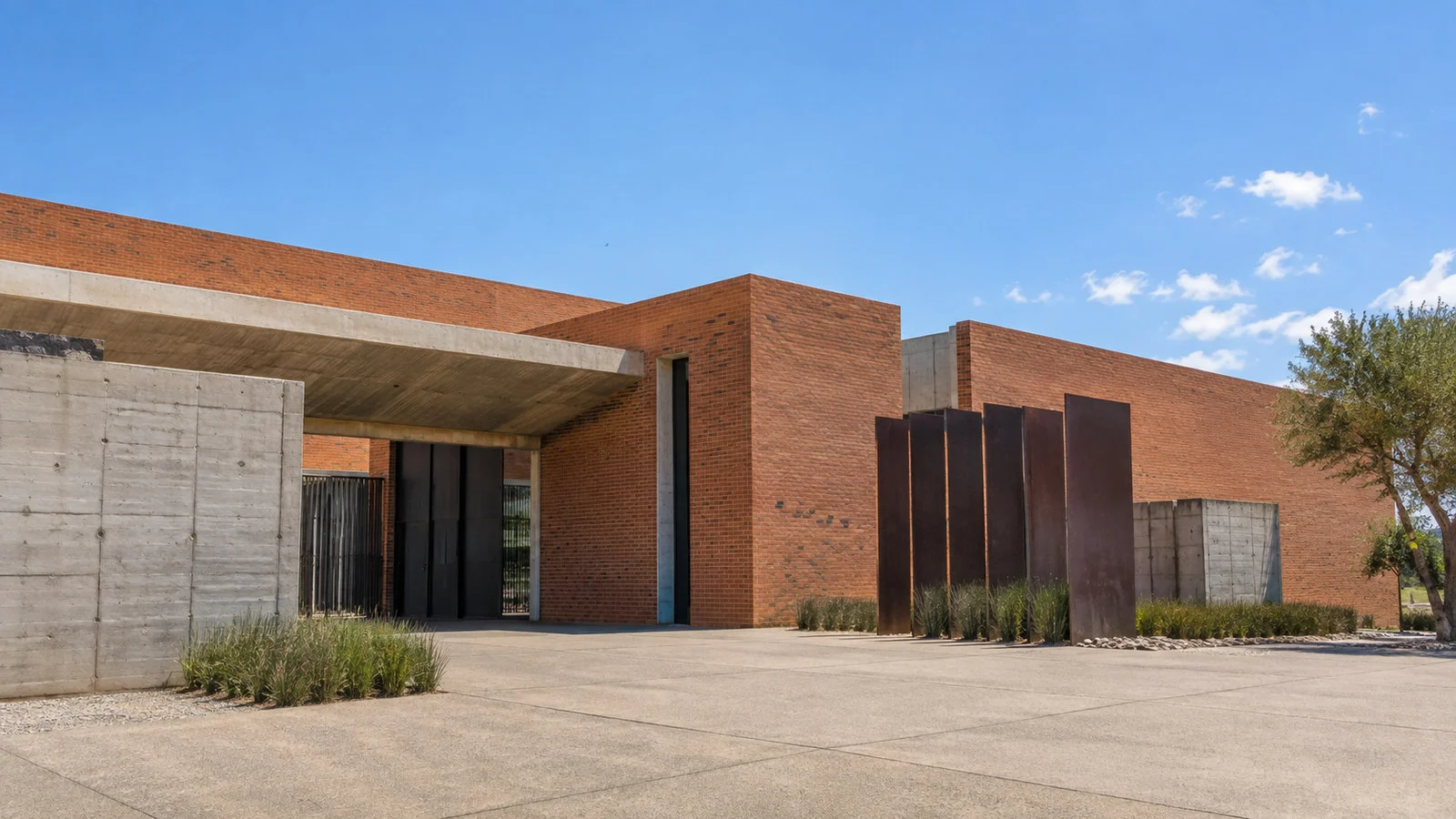 Apartheid Museum Johannesburg low modern brick and concrete exterior under blue sky, no people or readable text