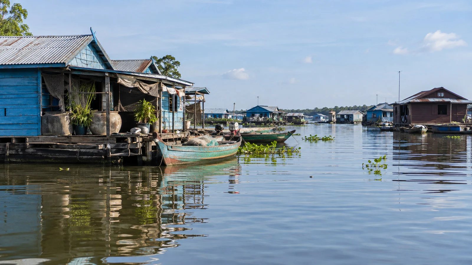 Floating village structures and boats near Kampong Chhnang Cambodia on Tonle Sap waterways, no people