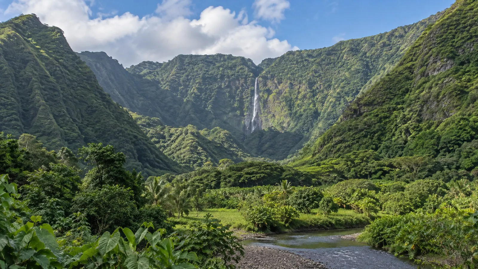 Halawa Valley Molokai Hawaii lush tropical valley and distant waterfall framed by green mountains, no people