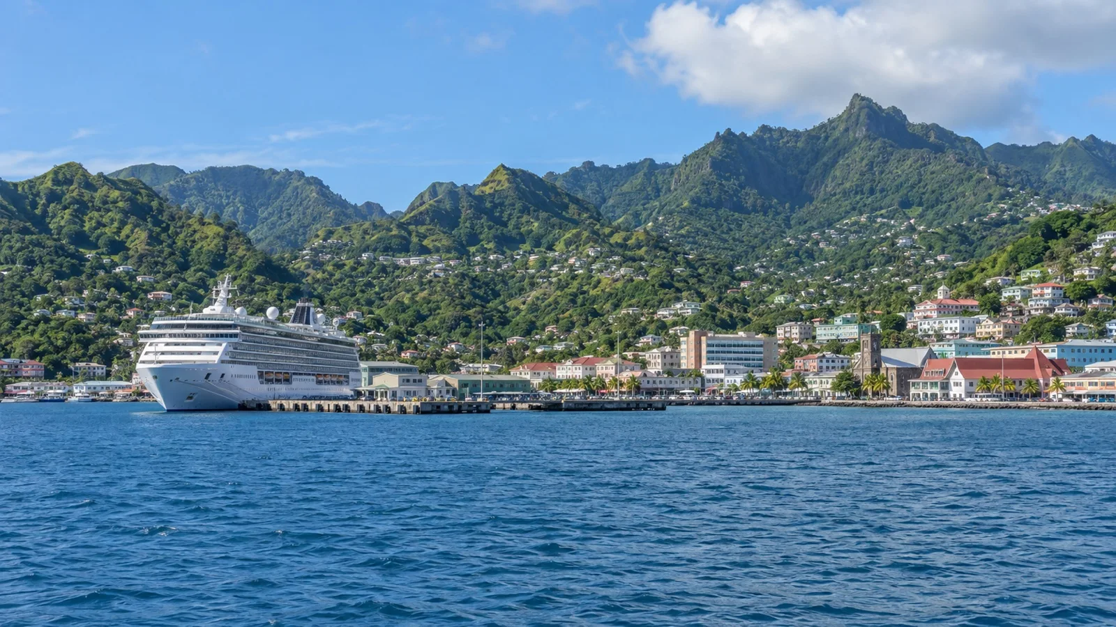 Cruise ship at Kingstown harbor below the green hills of Saint Vincent