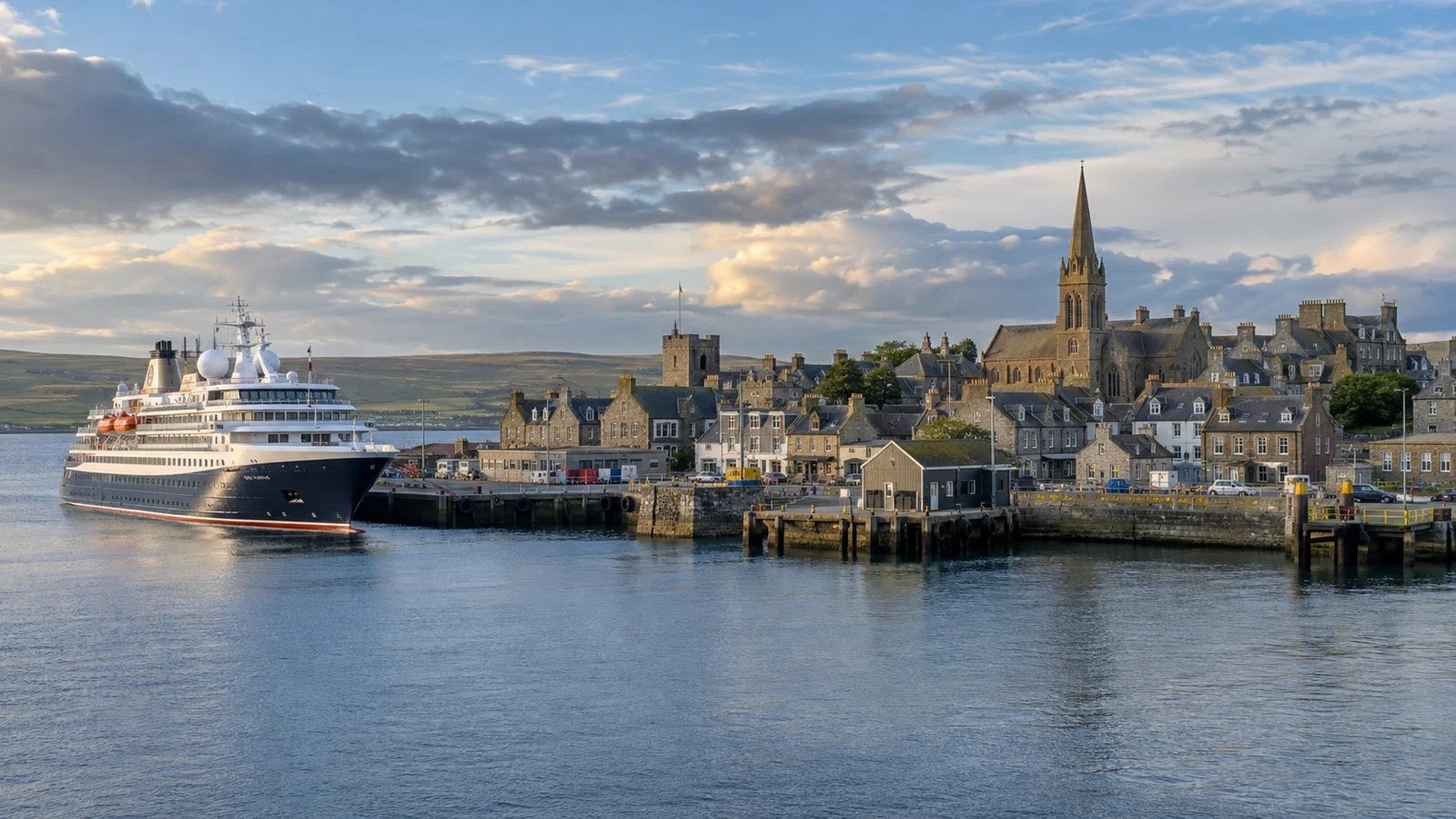 Kirkwall harbor in Orkney with a small cruise ship at the quay.