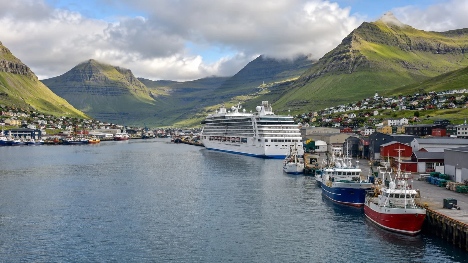 Cruise ship at Klaksvík quay beneath steep green mountains