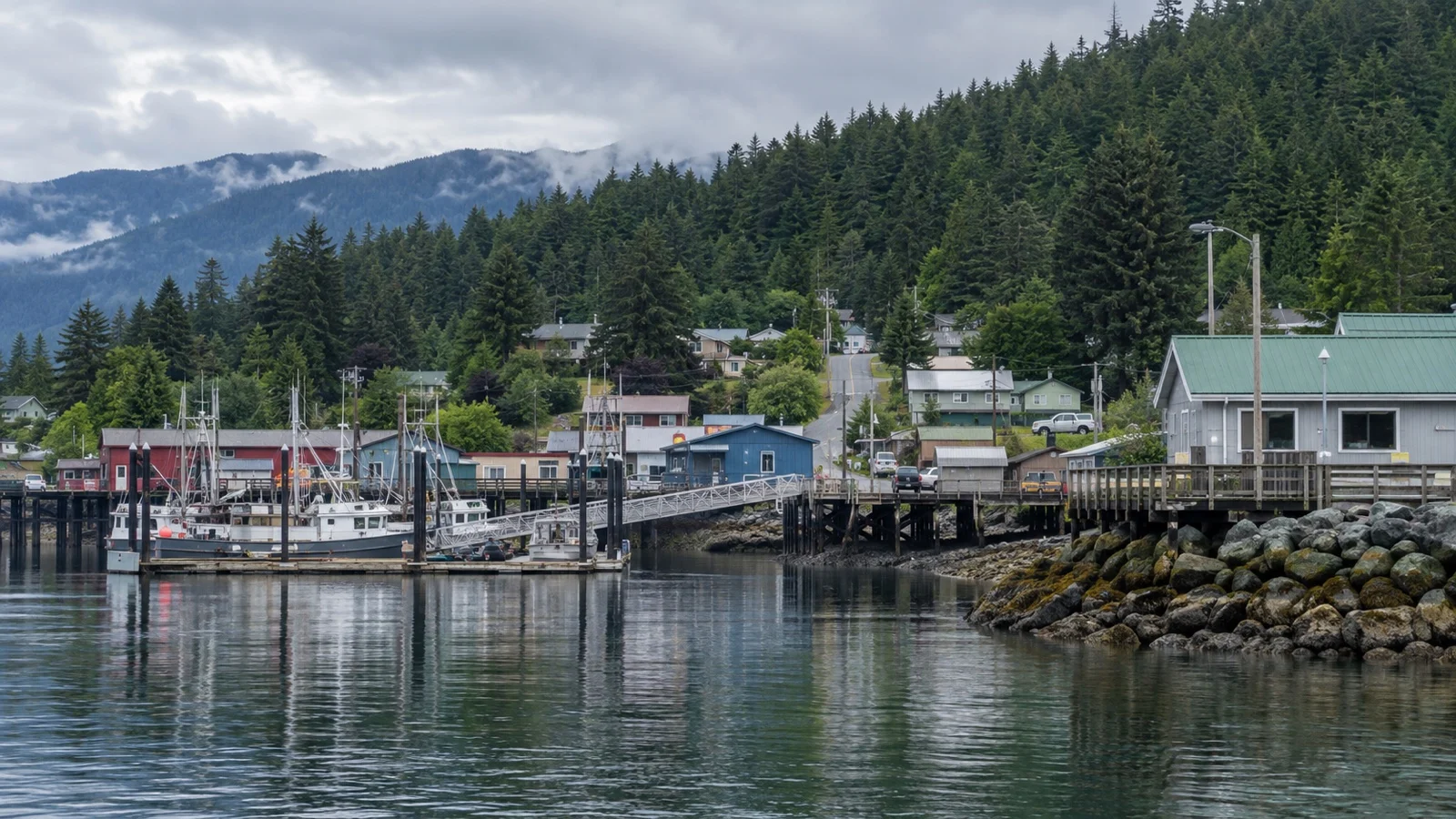 Quiet Klawock waterfront street and spruce-covered hills