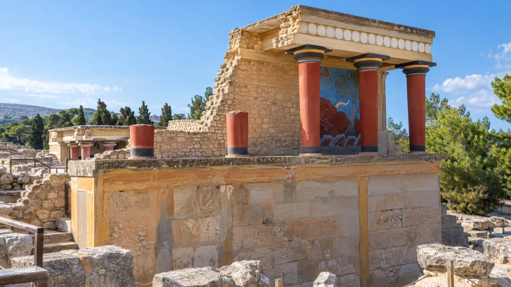 Red Minoan columns and stone ruins at Knossos near Heraklion