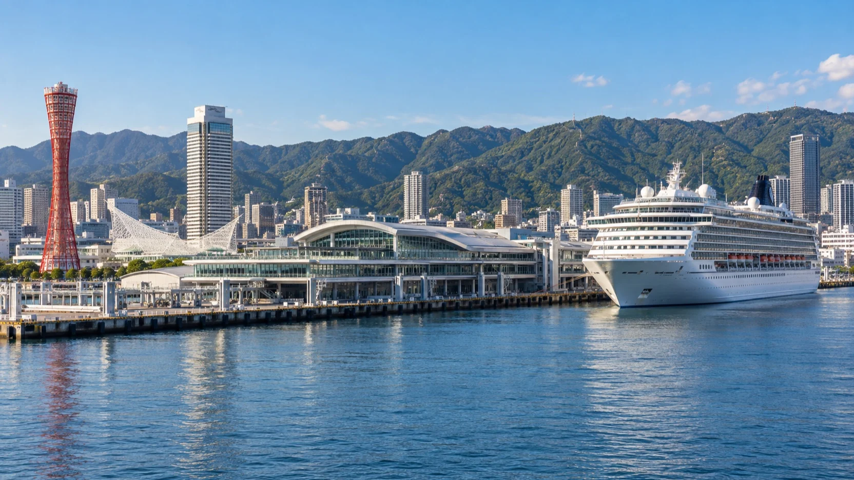 Cruise ship at Kobe harbor below the Rokko Mountains