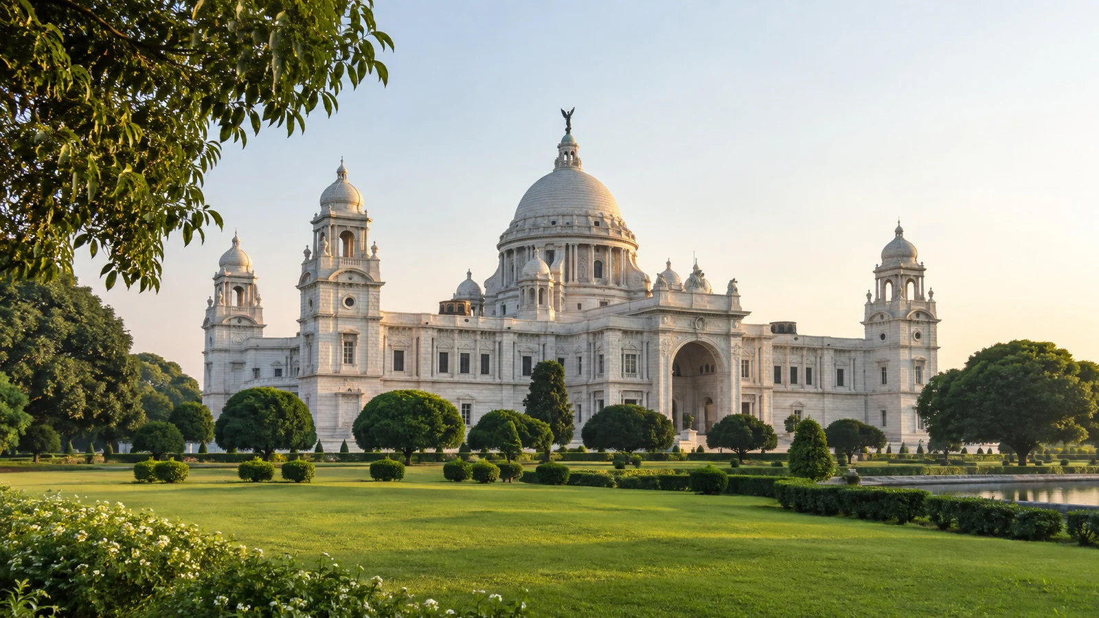 Victoria Memorial Kolkata white marble monument and green Maidan lawn in morning light, no people