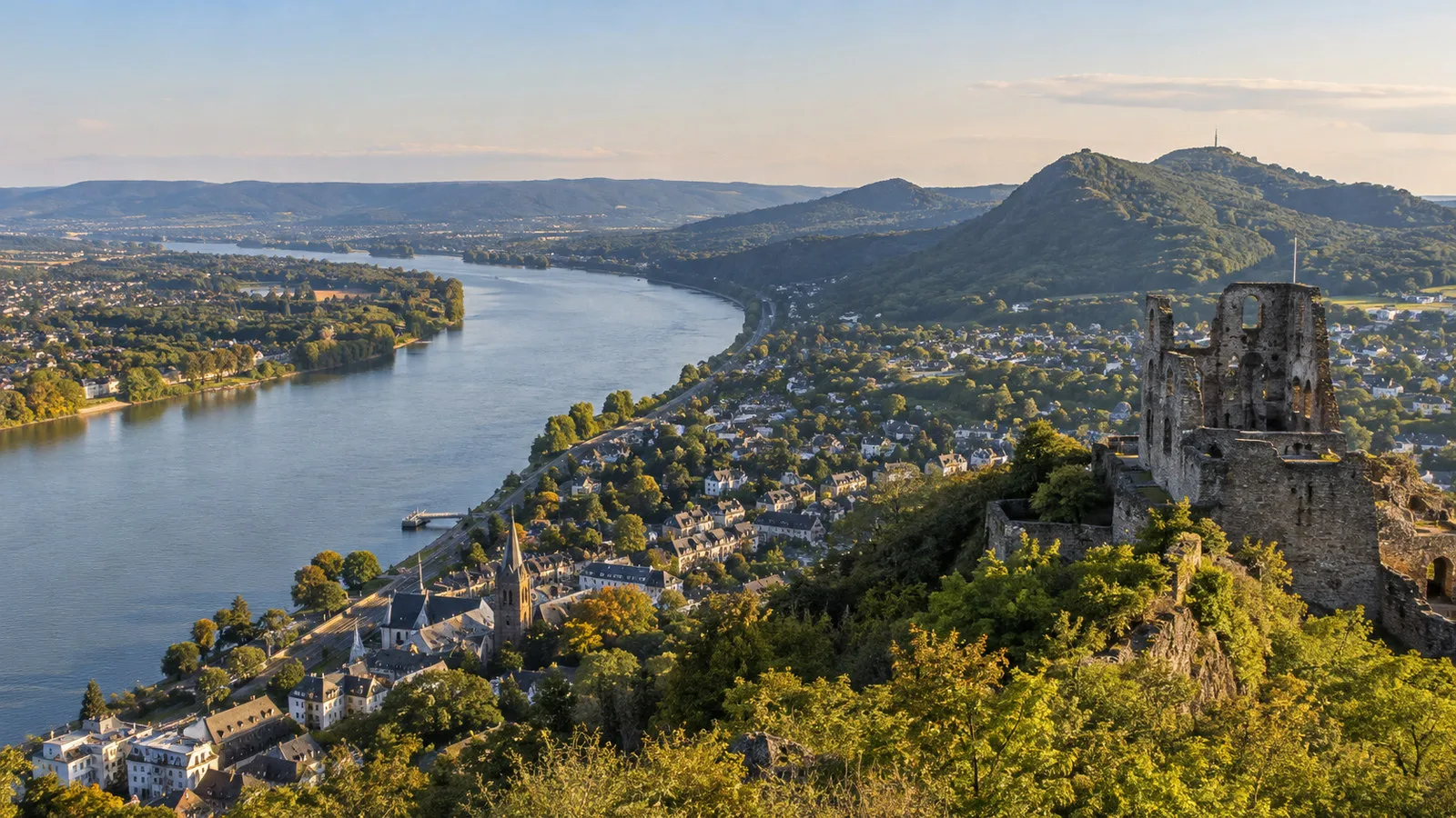 View from Drachenfels summit over Rhine river bend and Konigswinter with castle ruins, no people