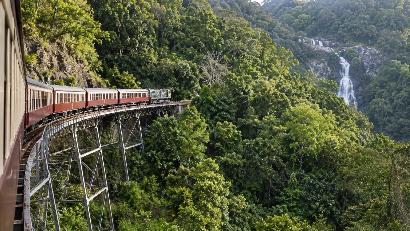 Kuranda Scenic Railway crossing a trestle through tropical rainforest near Cairns.