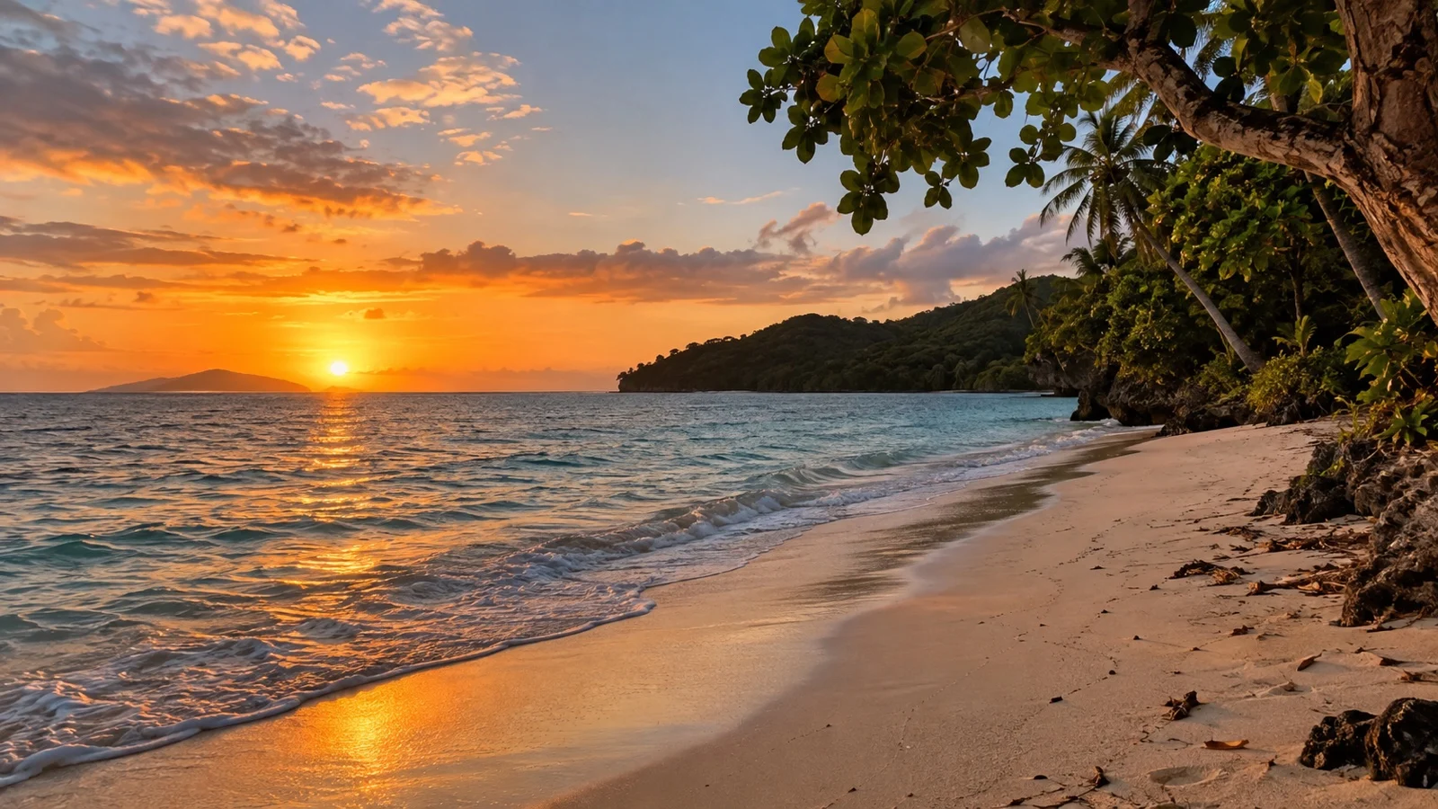 Quiet undeveloped west-facing sandy beach on Lelepa Island at warm sunset