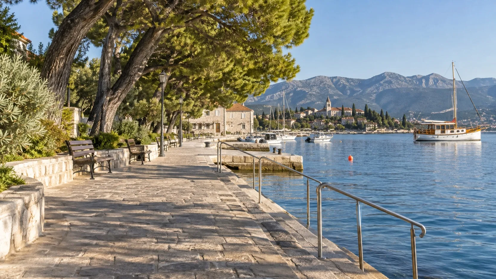 Level waterfront path with benches, shade and handrails