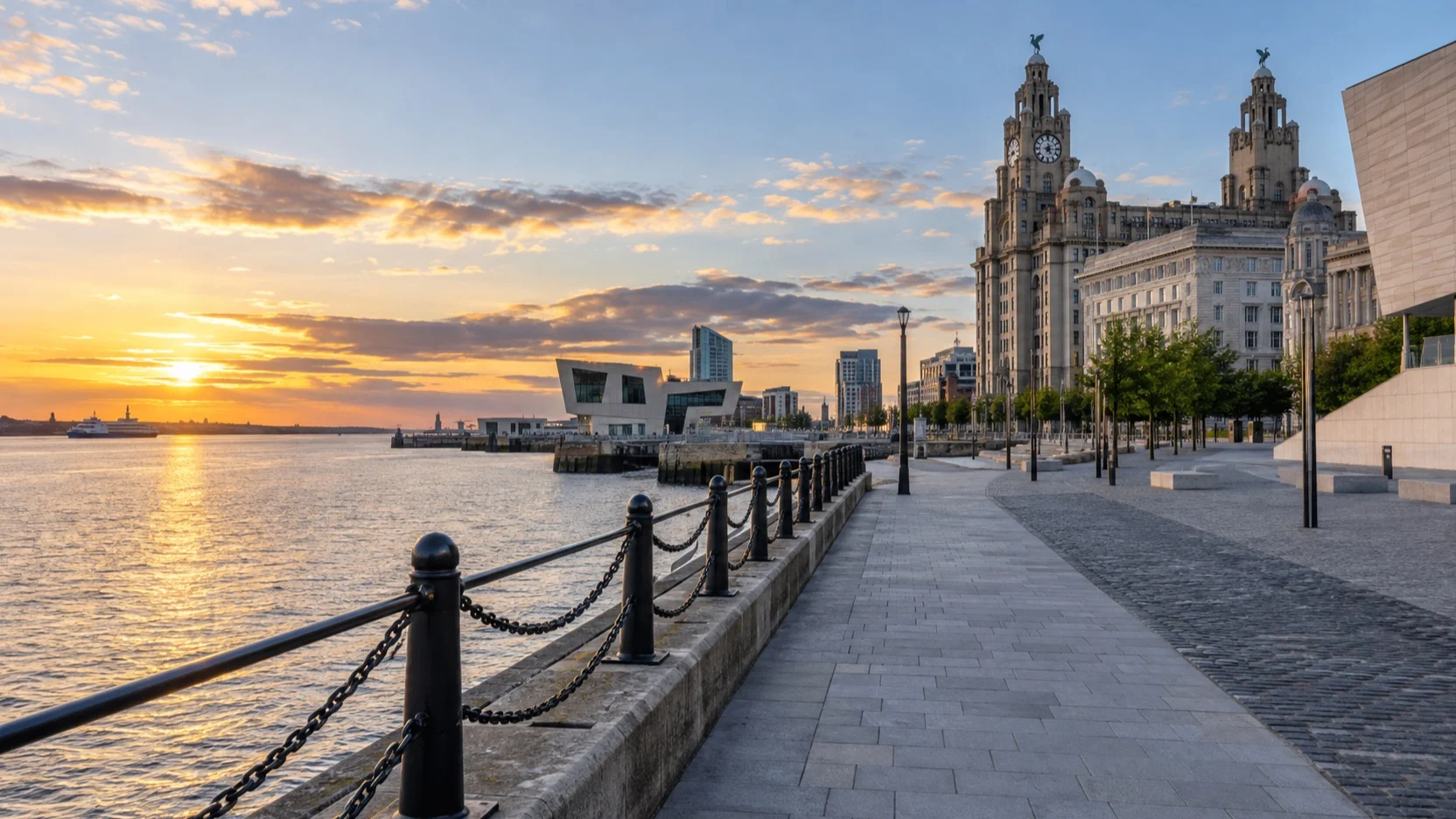 A quiet waterfront promenade and Royal Liver Building beside the River Mersey