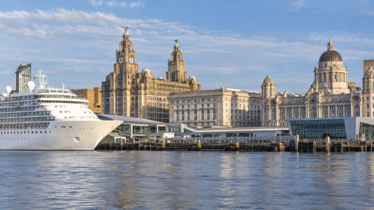Liverpool Cruise Terminal at Pier Head with a white cruise ship beside the Mersey and Three Graces waterfront buildings