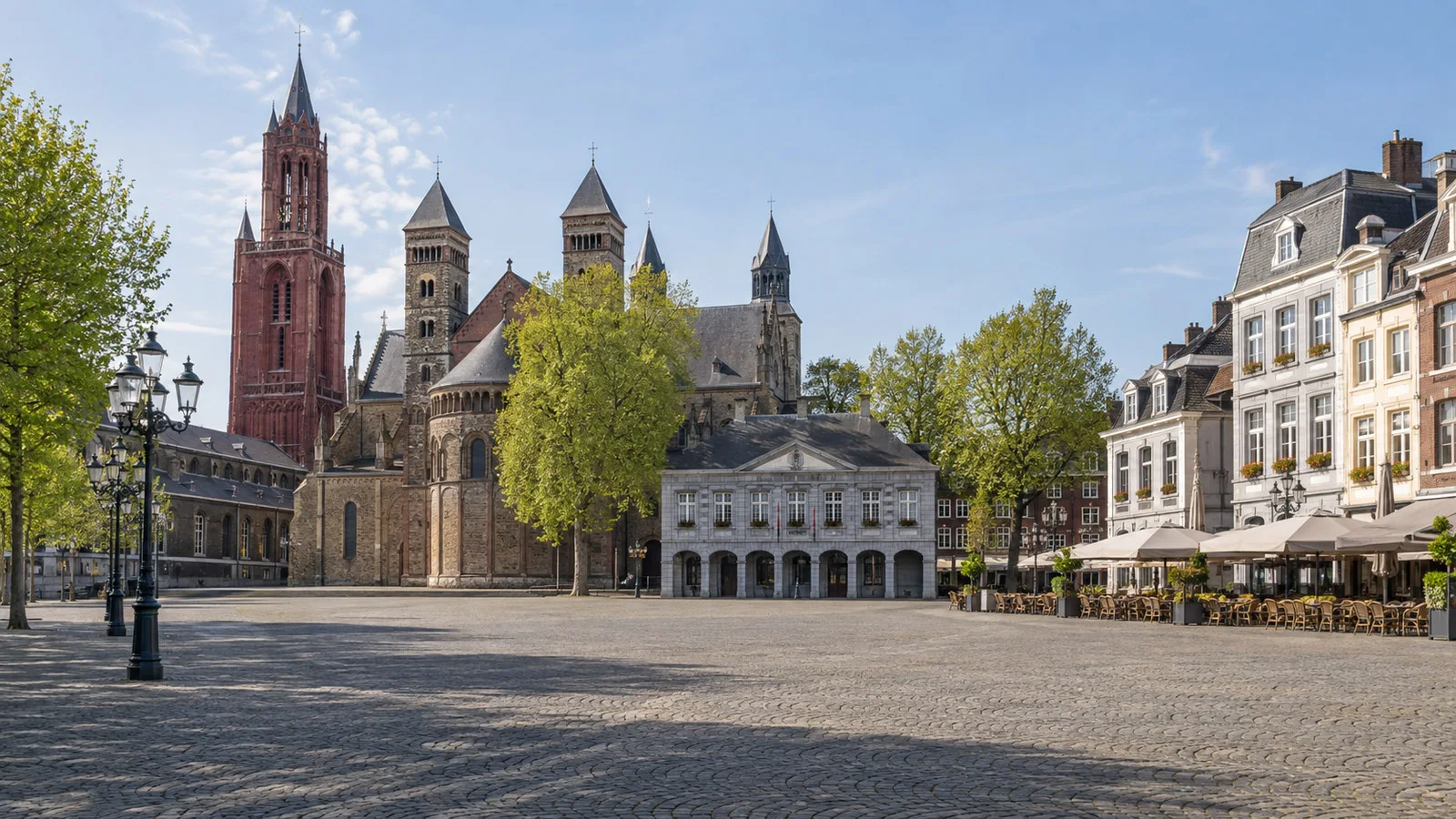 Vrijthof square in Maastricht with historic churches and café buildings, empty of people